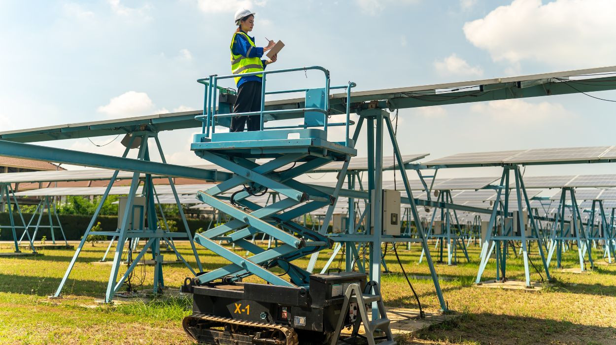 Man standing on a MEWP installing Solar Panels