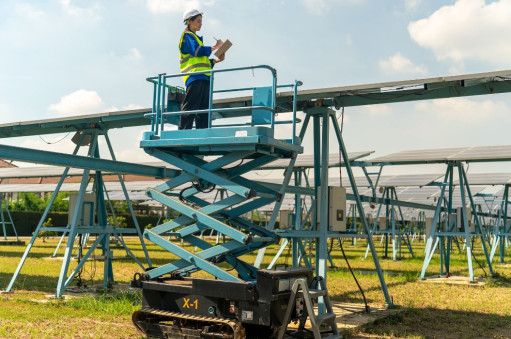 Man standing on a MEWP installing Solar Panels